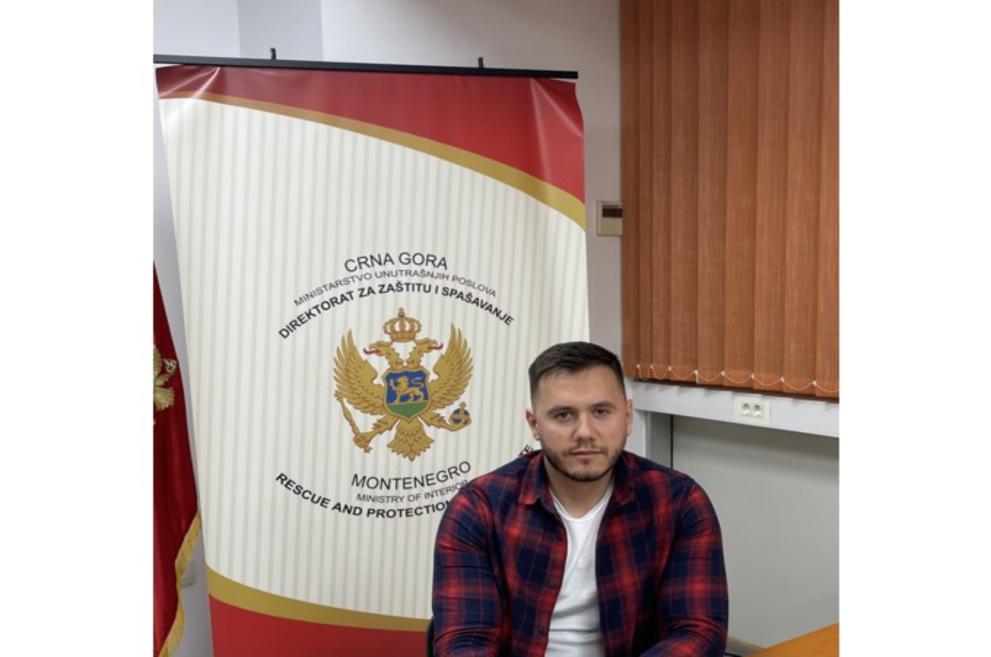 Stefan Sošić in front of an exhibition panel of the Montenegro Ministry of Interior Rescue and Protection Directorate 