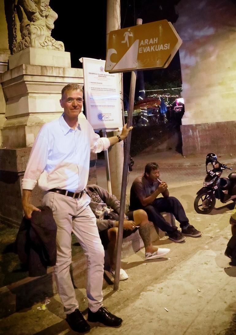 Professor Behrens next to tsunami evacuation signs