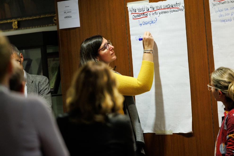 person writing on a flipchart at a workshop