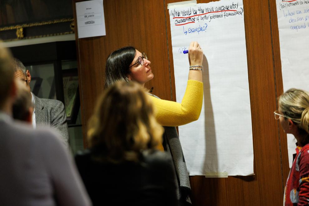 person writing on a flipchart at a workshop