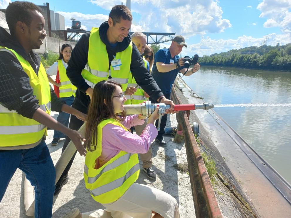 participants holding a hose