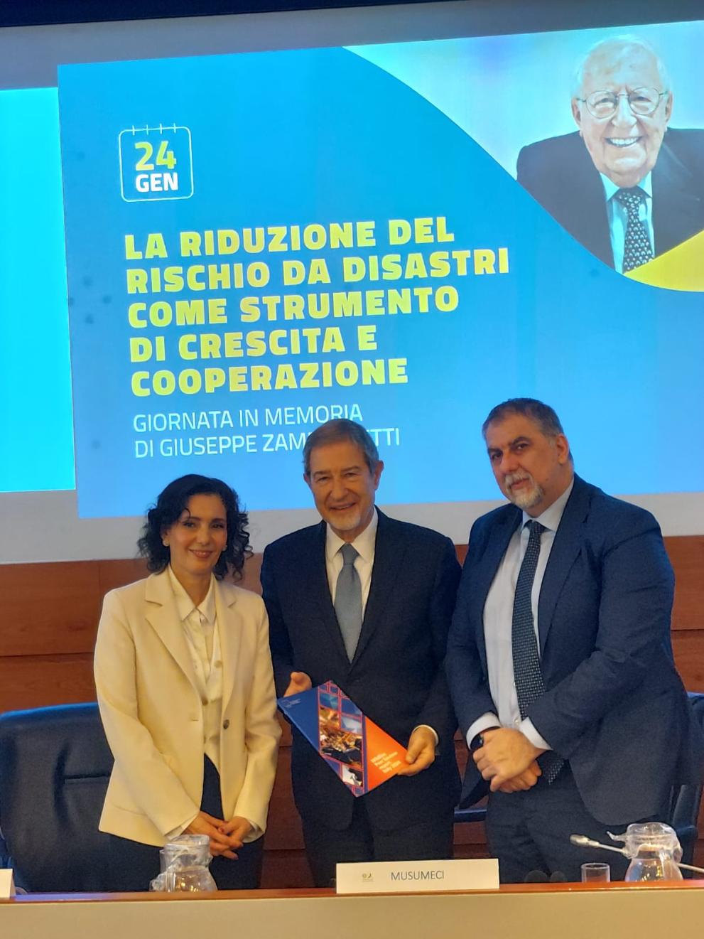 EU Commissioner Lahbib stands next to the Italian Minister for Civil Protection and Maritime Policy, Nello Musumeci. To the right of him is Director General, Ciciliano.