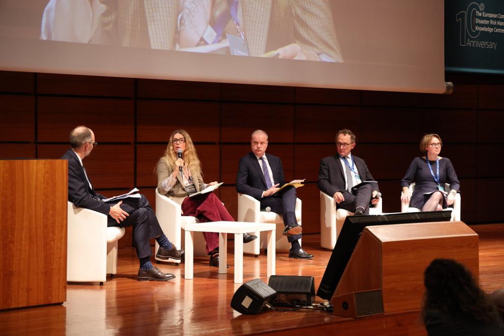Panel of participants presenting their work during the event.
