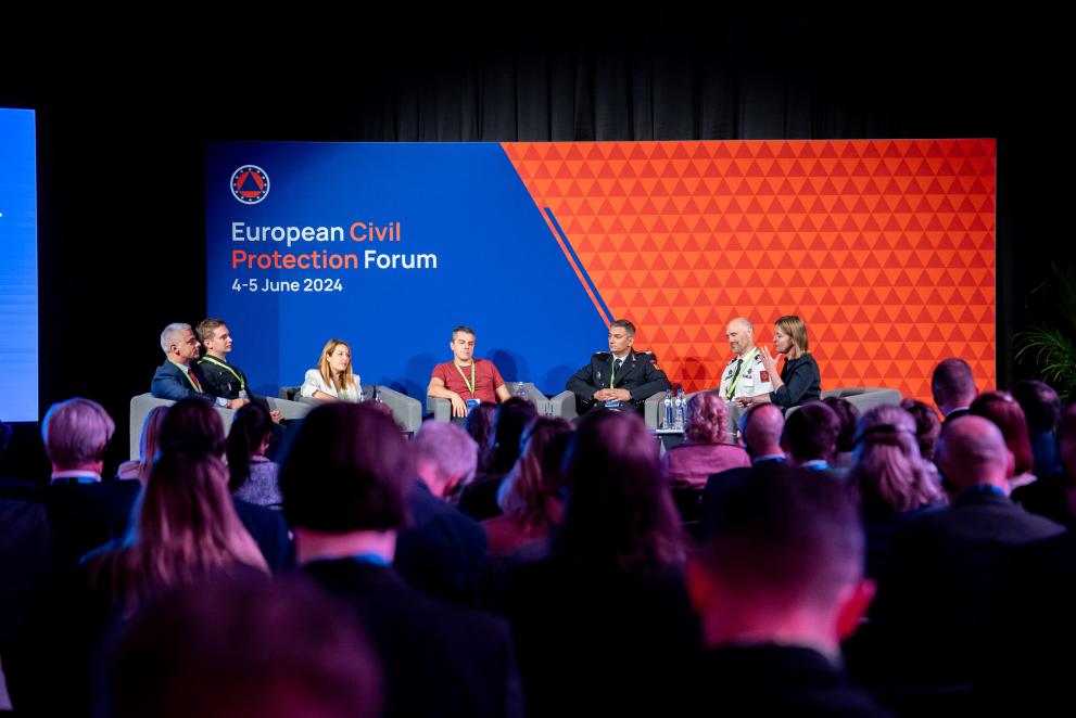 Seven panelists during the Civil Protection Forum 2024 on stage. 