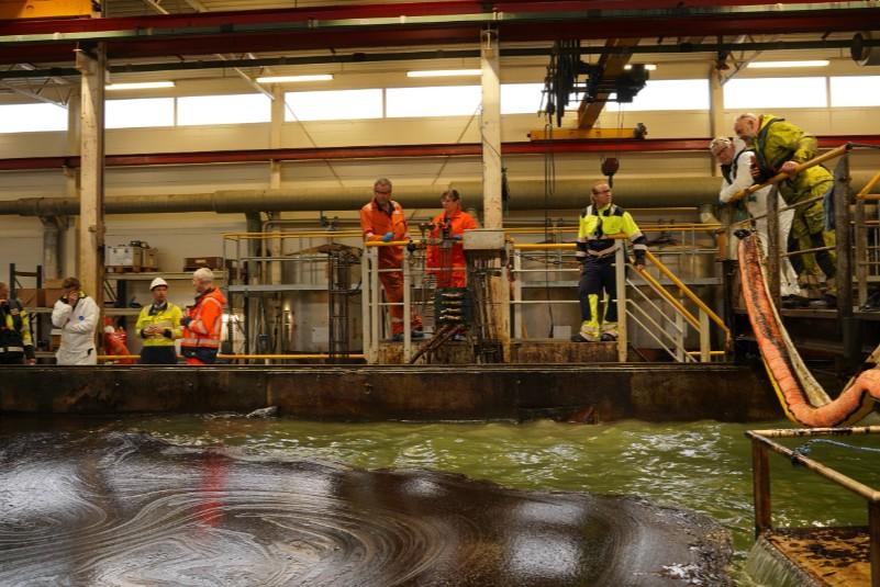 A group of civil protection experts during a testing of oil recovery.
