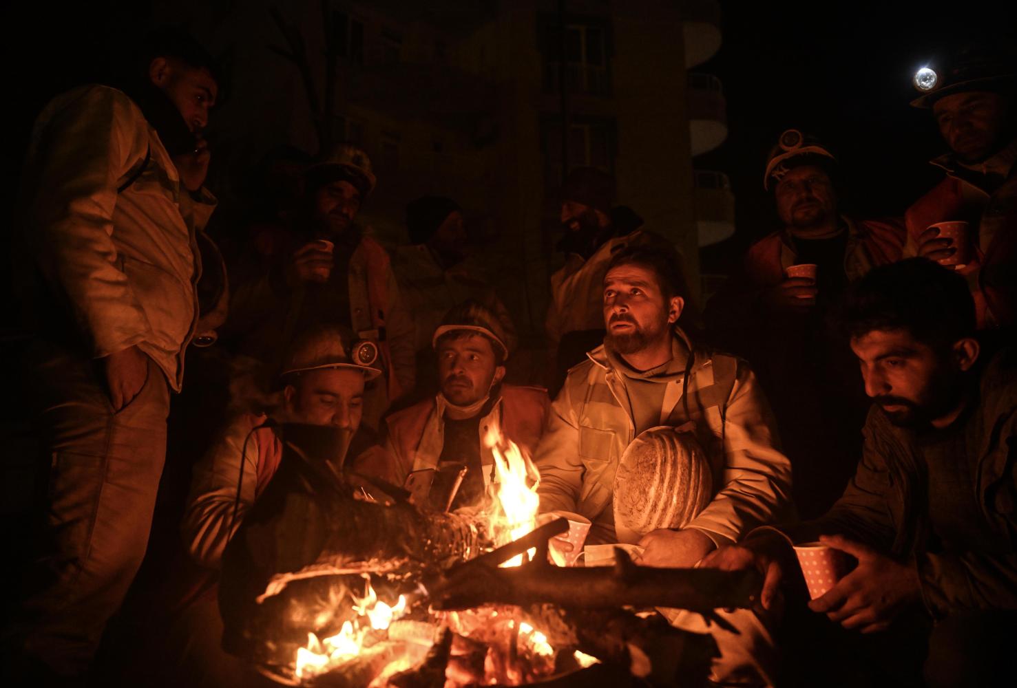Miners gathered around a fire after a hard day 
