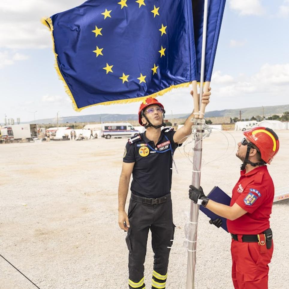 Participants of the EU MODEX exercise with an EU flag