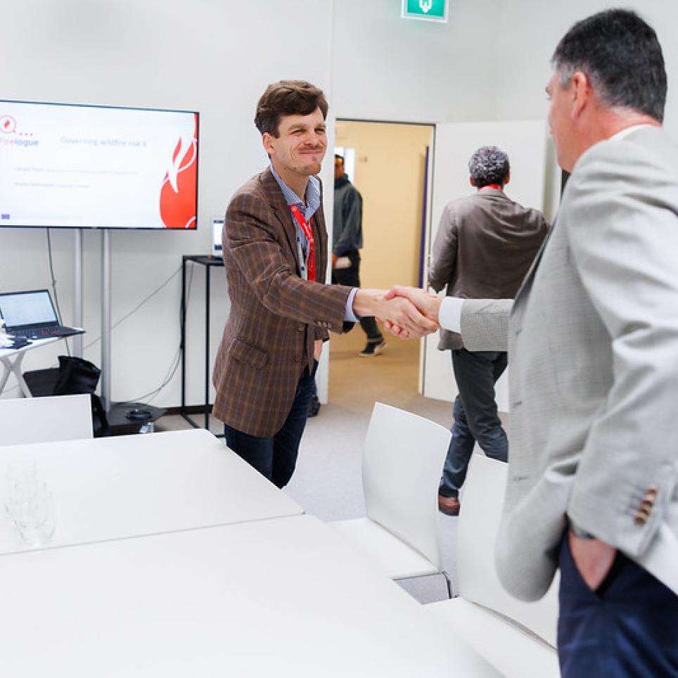 Handshake during one of the thematic workshops.