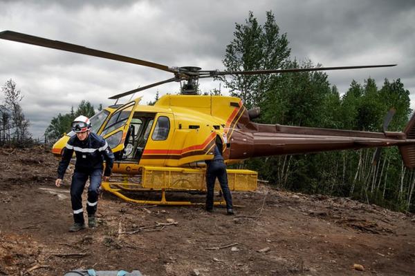 Captain Jerome Jallet from France walks away from a helicopter after an aerial survey of the woodlands his team is working in.