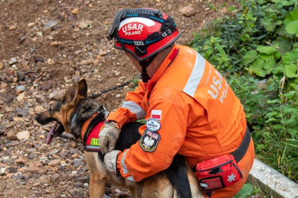 First responder with service dog, seated during an exercise.