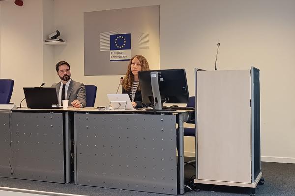 Two participants during a presentation at the last UCPM Track-1 Call.