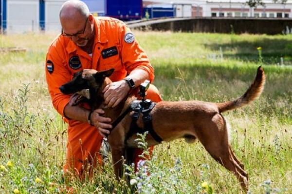 After a successful search and rescue exercise, Ad shares a well-earned hug with his loyal partner Bartje.
