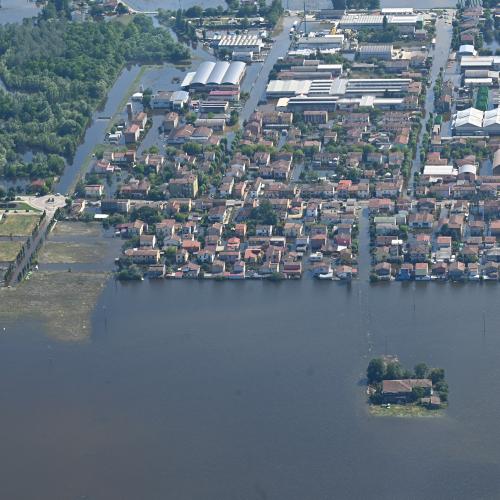 Aerial view of a flooded town in Emilia Romagna, Italy. The flood waters have surrounded the houses, leaving some completely cut off.