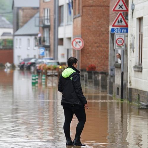 Woman walking in a street affected by floods