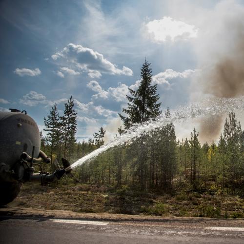 Water truck extinguishing a wildfire.