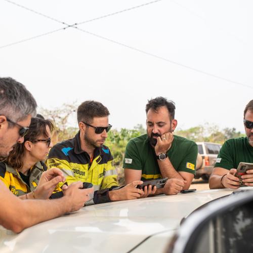Abraham Hernandez Jacinto (middle left) analyses data on a cellphone