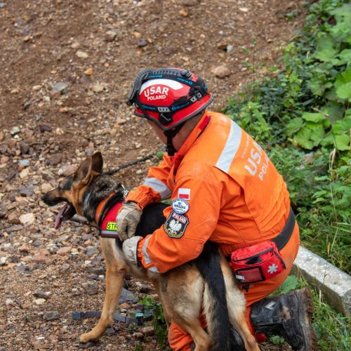 First responder with service dog, seated during an exercise.