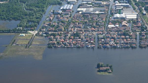 Aerial view of a flooded town in Emilia Romagna, Italy. The flood waters have surrounded the houses, leaving some completely cut off.