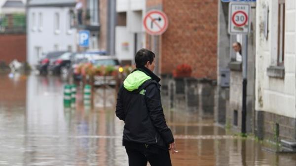 Woman walking in a street affected by floods