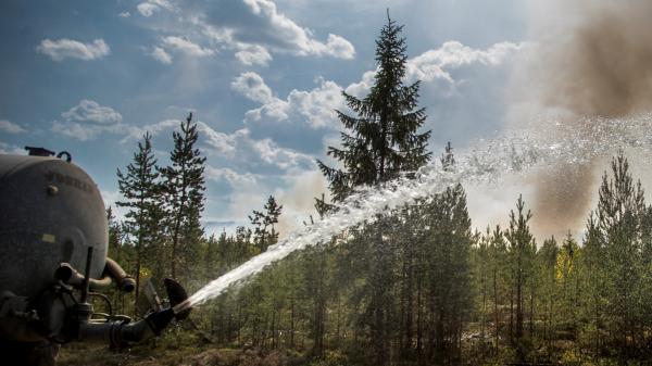 Water truck extinguishing a wildfire.