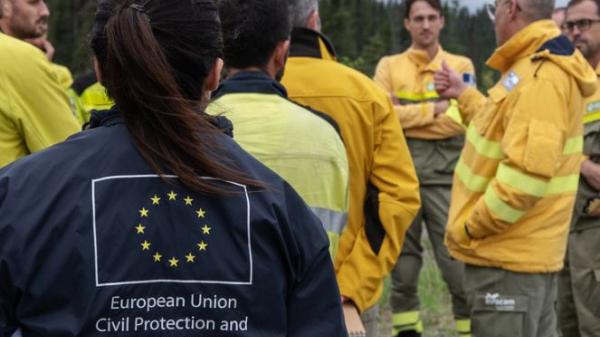 Spanish firefighters talk and get information for the coming days at their basecamp in Roberval, Quebec.