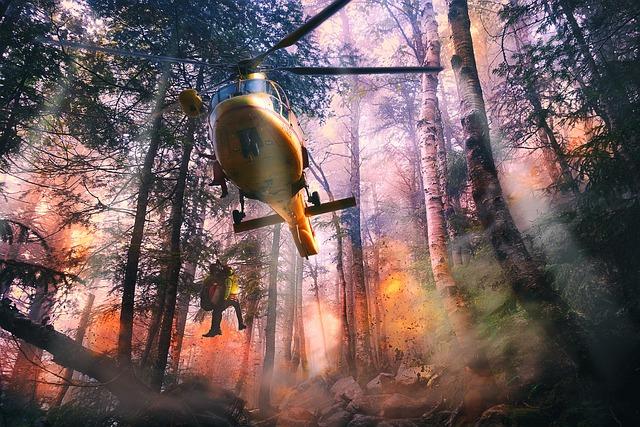 Emergency helicopter in a burning forest