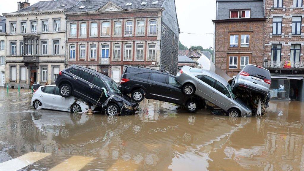 Cars pile up by the water at a roundabout in the Belgian city of Verviers after heavy rain and flooding hit western Europe. FRANCOIS WALSCHAERTS - AFP
