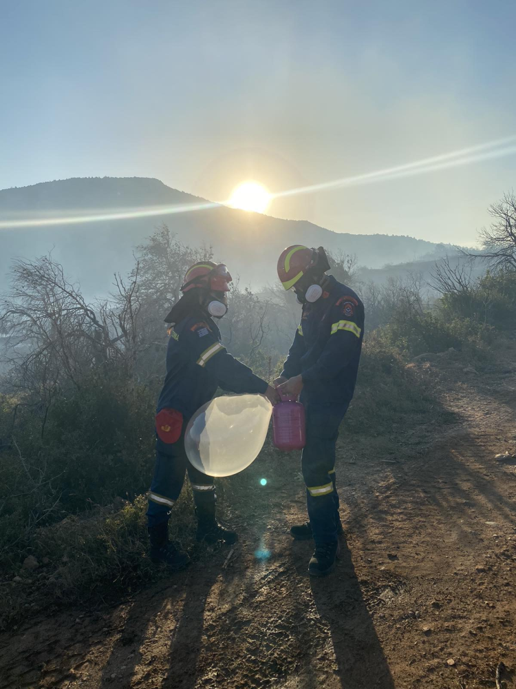 Firefighters from the HFS prepare a radiosonde for launching it during the 2024 Katsimidi fire, municipality of Acharnon, Greece, on 29 June 2024.