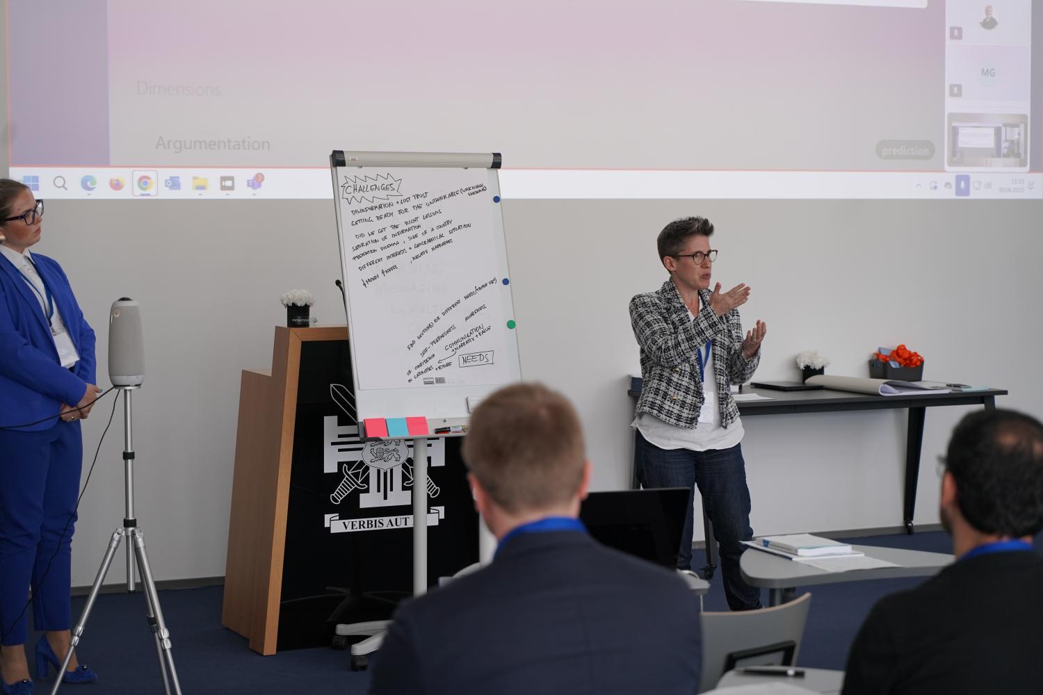 A participant presenting the results of their group discussion to the audience.