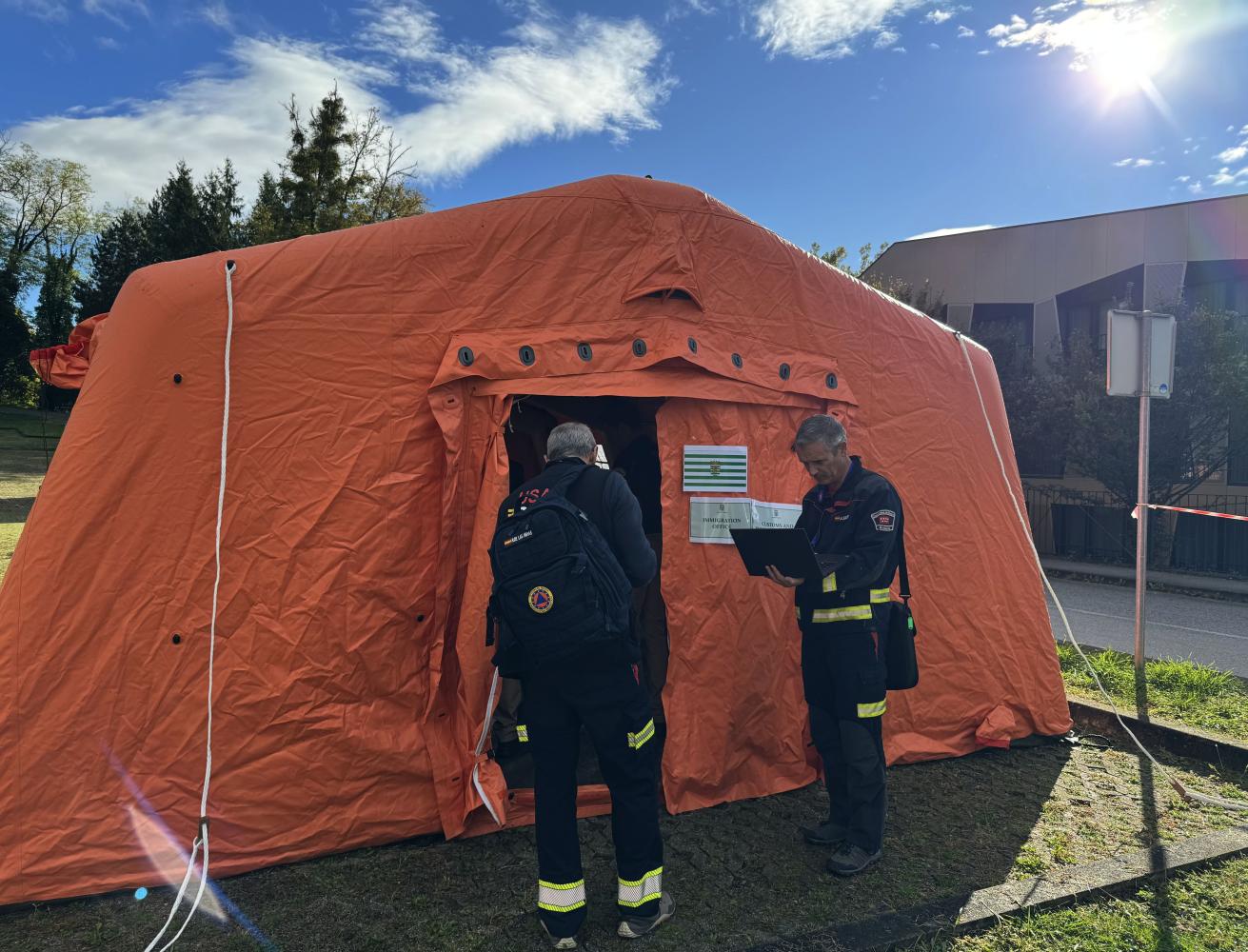 Modules personnel enter a tent at the exercise.