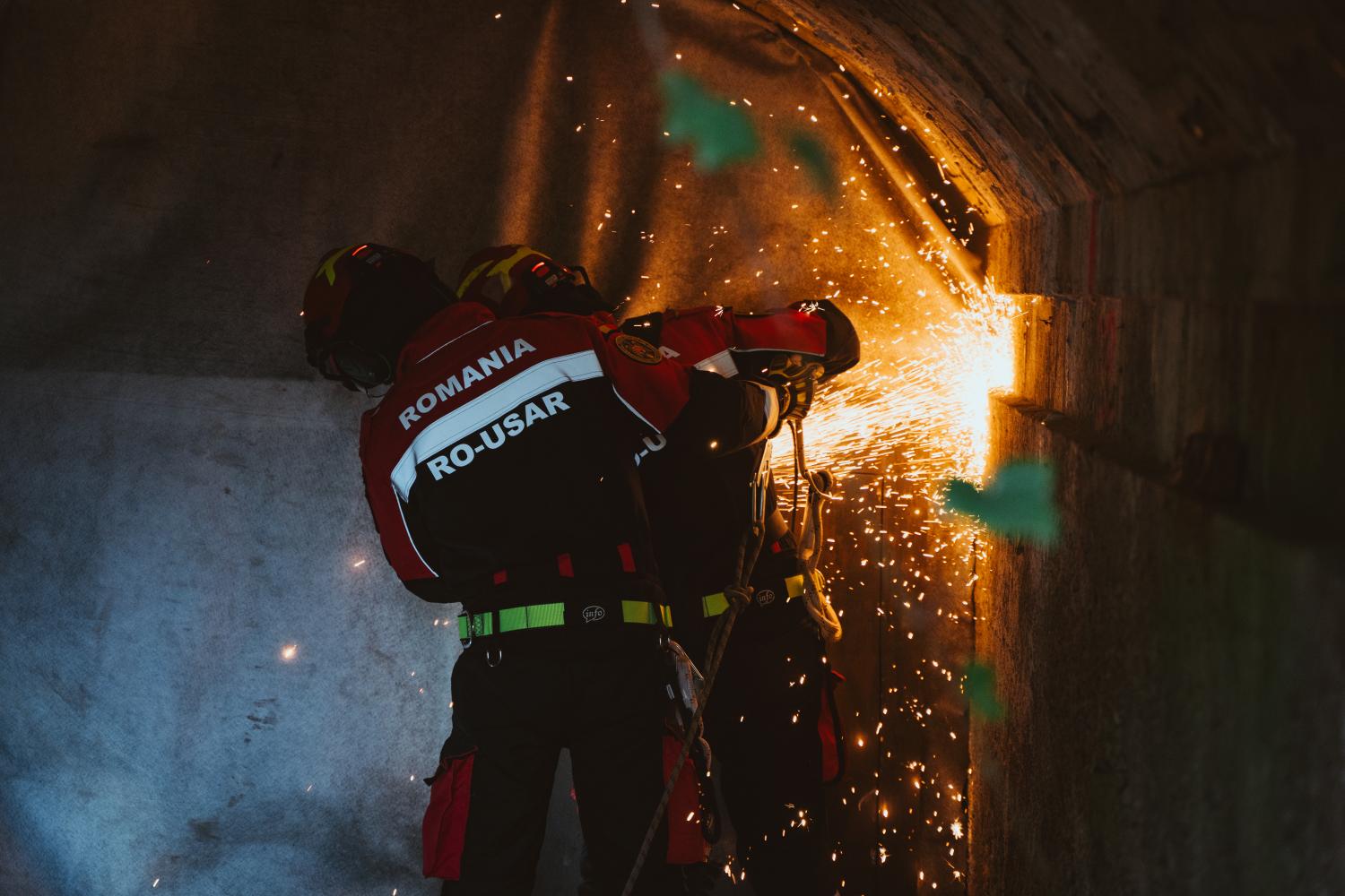 RO MUSAT is shown using heavy machinery to rescue a victim.