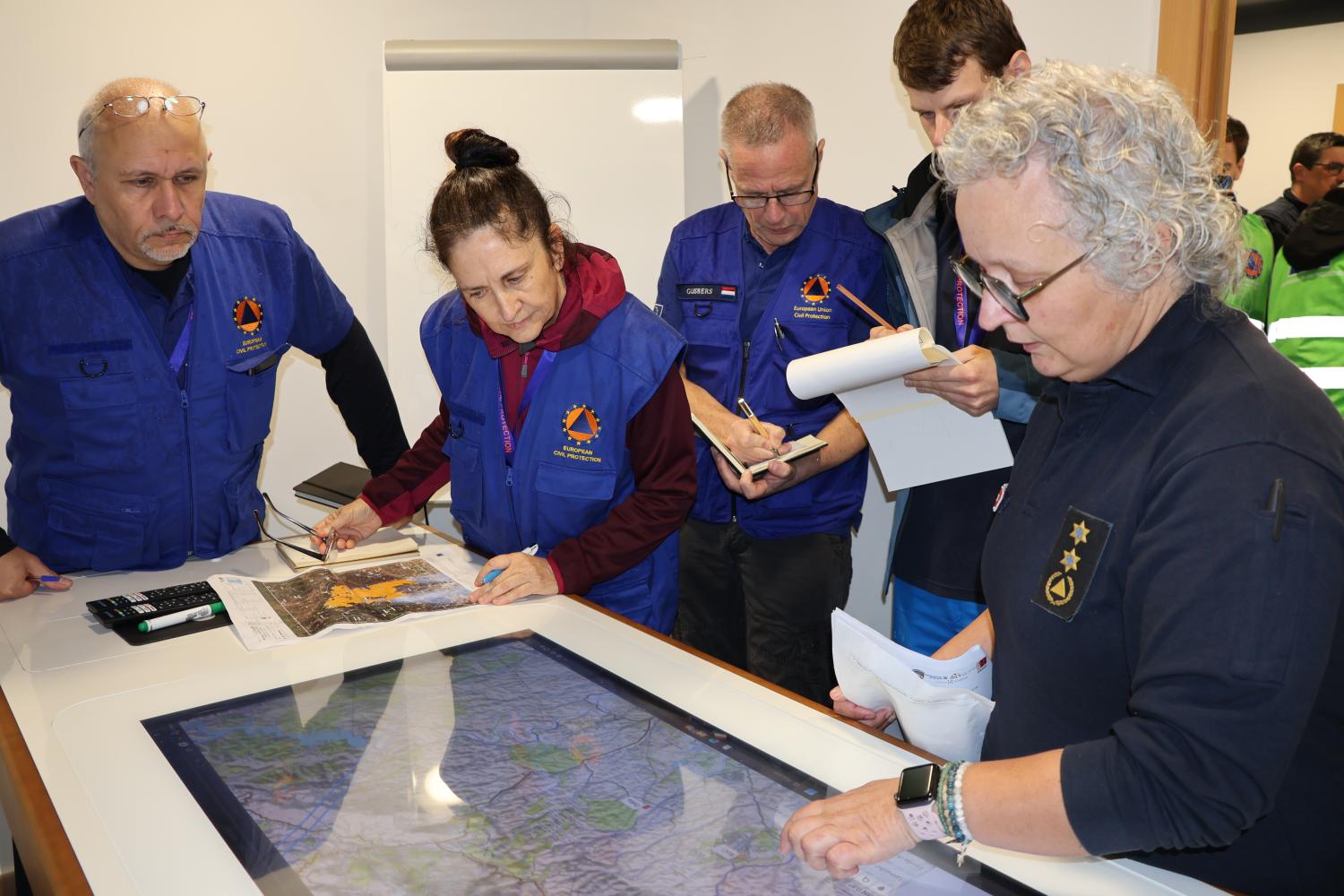Participants attend a meeting with the incident commander.