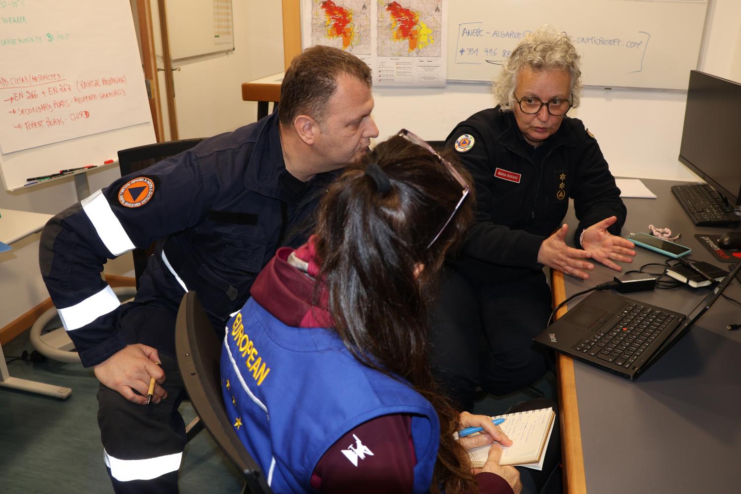Participants attend a meeting with the incident commander.