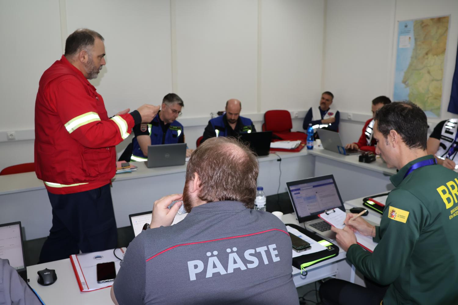 Participants attend a meeting with the on site commander.