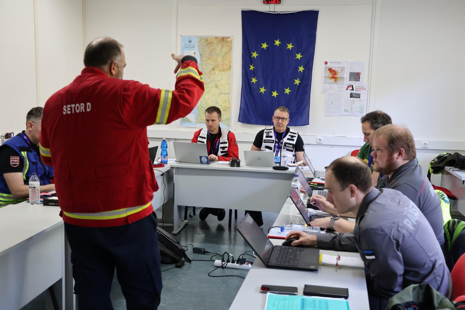 Participants attend a meeting with the on site commander.