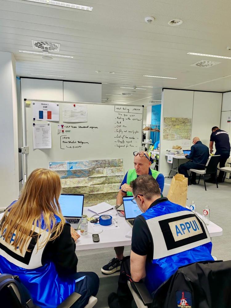 Modules at their workspace, discussing exercise with Coach/Trainer