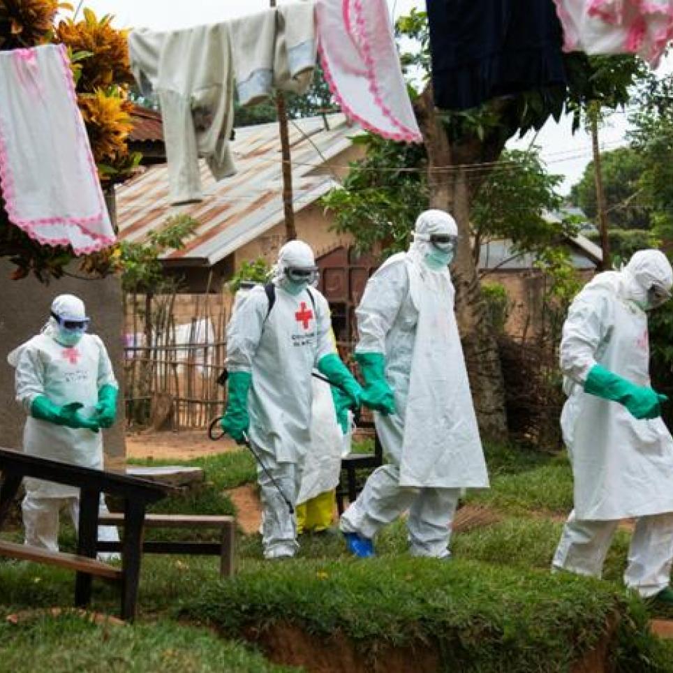 An IFRC safe and dignified burial team respond to an alert from family members who have lost a loved one suspected of Ebola.  Photo: IFRC/Maria Santto