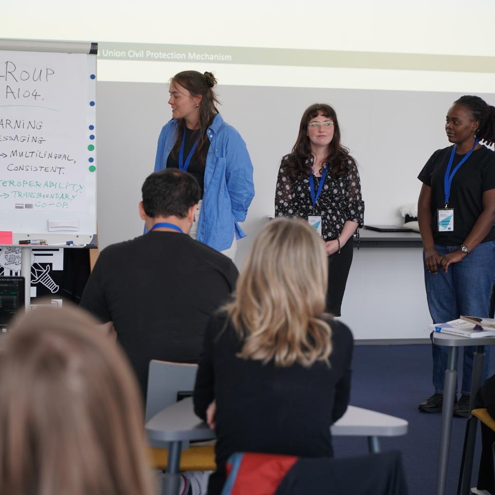 One of the four groups presenting their discussion results to the class.