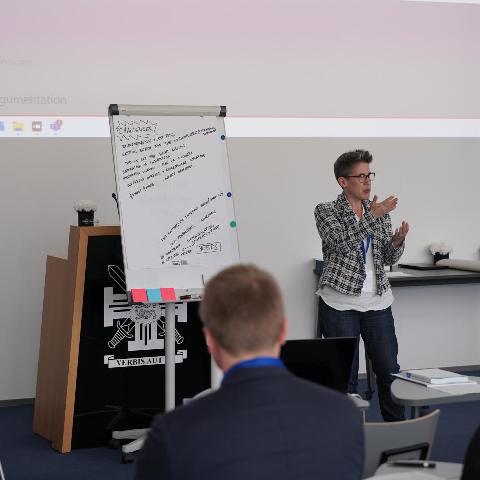 A participant presenting the results of their group discussion to the audience.