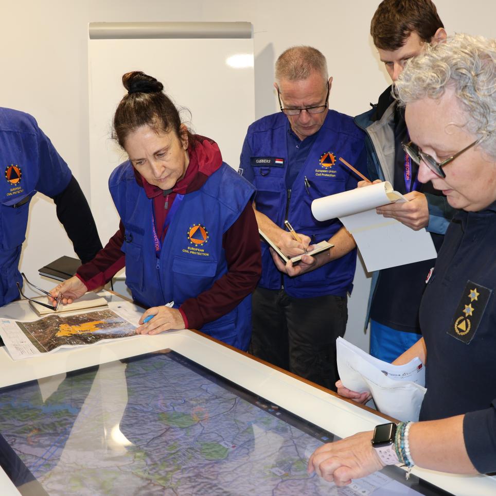 Participants attend a meeting with the incident commander.