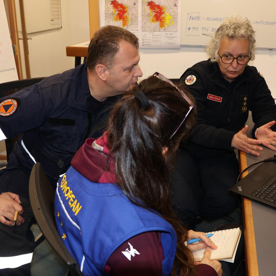 Participants attend a meeting with the incident commander.