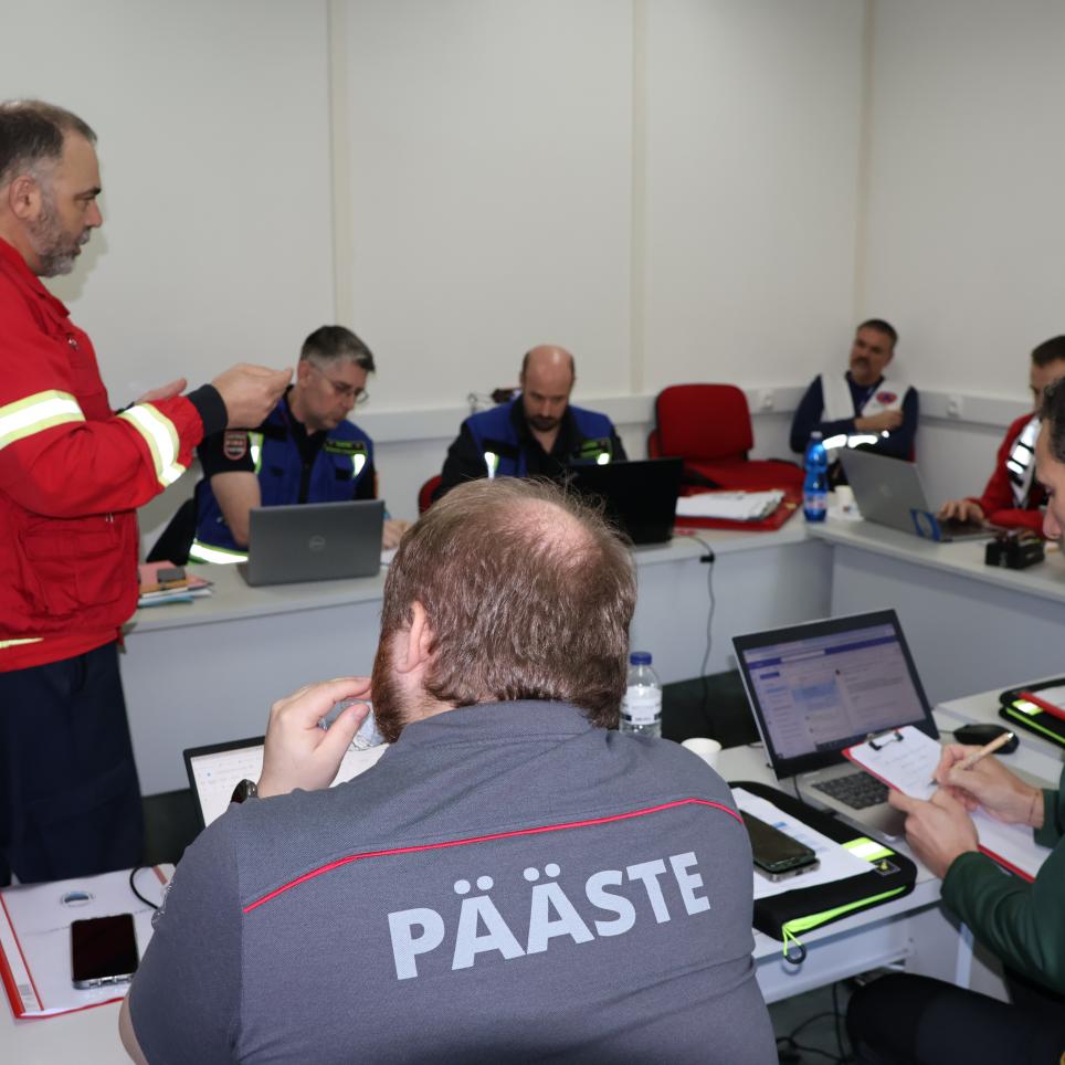 Participants attend a meeting with the on site commander.