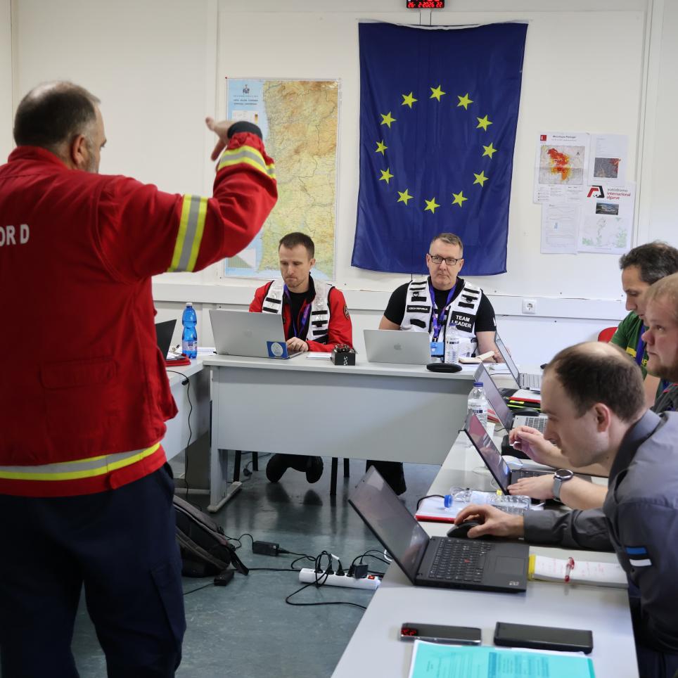 Participants attend a meeting with the on site commander.