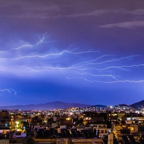 Тhunderstorms with Lightning strikes above a city
