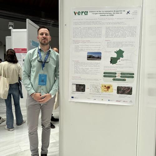 A photo of the poster with Emilio de Diego (METEOGRID) standing beside it. 