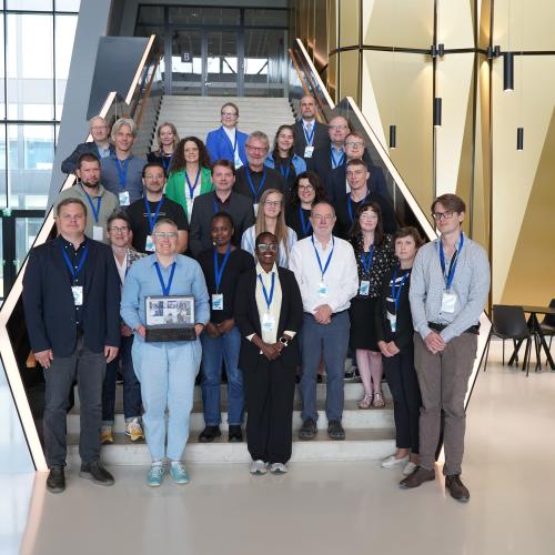 Workshop participants standing on the staircase in the hallway of the Estonian Academy of Security Sciences.