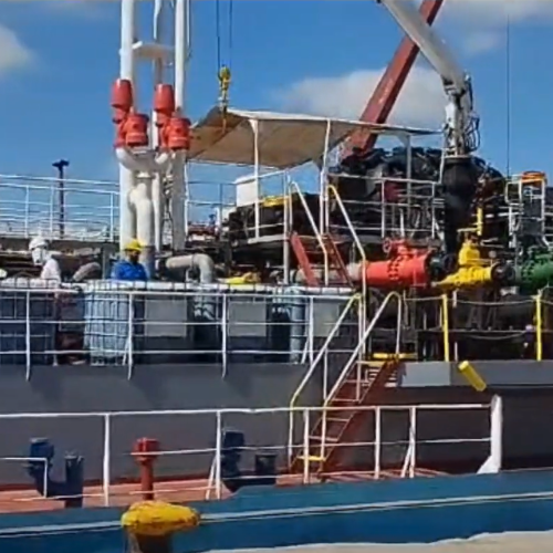 Loading oil from a ship.