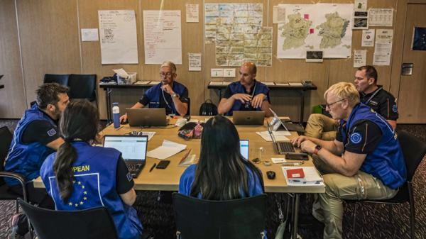 The EUCP Team is sitting at a table, planning and discussing as part  of the Modules Table Top Exercise.