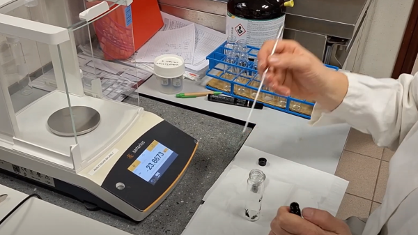 Woman checking the weight of oil