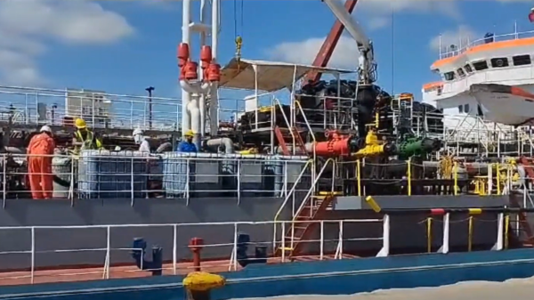 Loading oil from a ship.